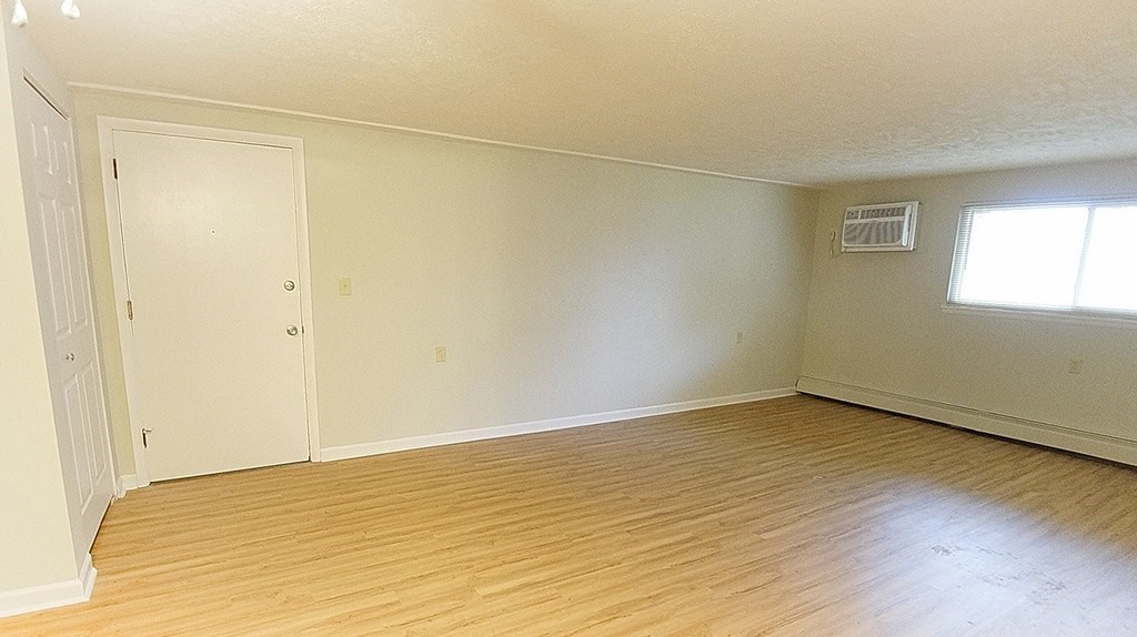 A room with a white door and a window.