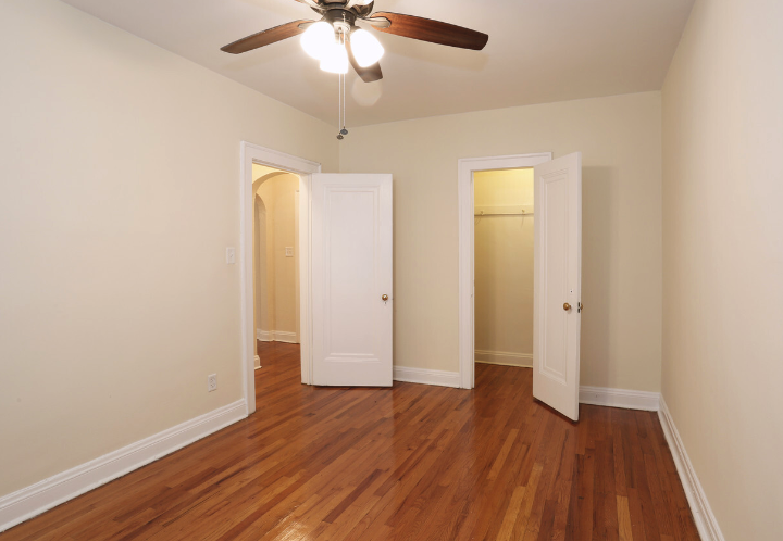 a living room with wood floors and a ceiling fan