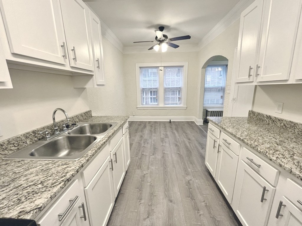 Lewis Manor renovated kitchen with white cabinets and marble countertops.