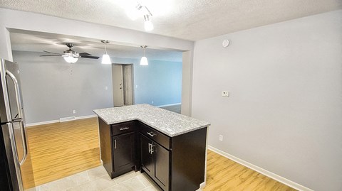 a kitchen with a island and a ceiling fan