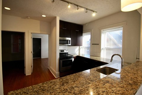 A kitchen with granite countertops and a sink.