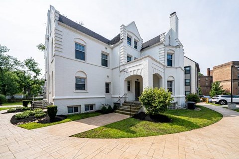 Historic white building with landscaped courtyard at Reserve Overlook* Apartments, Cleveland Heights, OH
