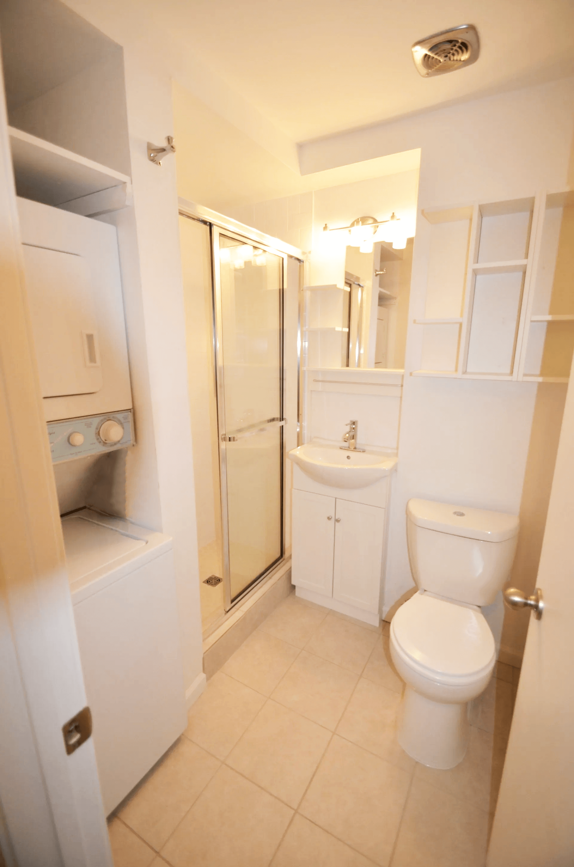 a white bathroom with a toilet and a shower