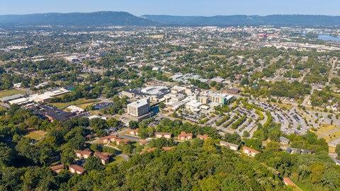 A bird's eye view of a city with a large building in the center.