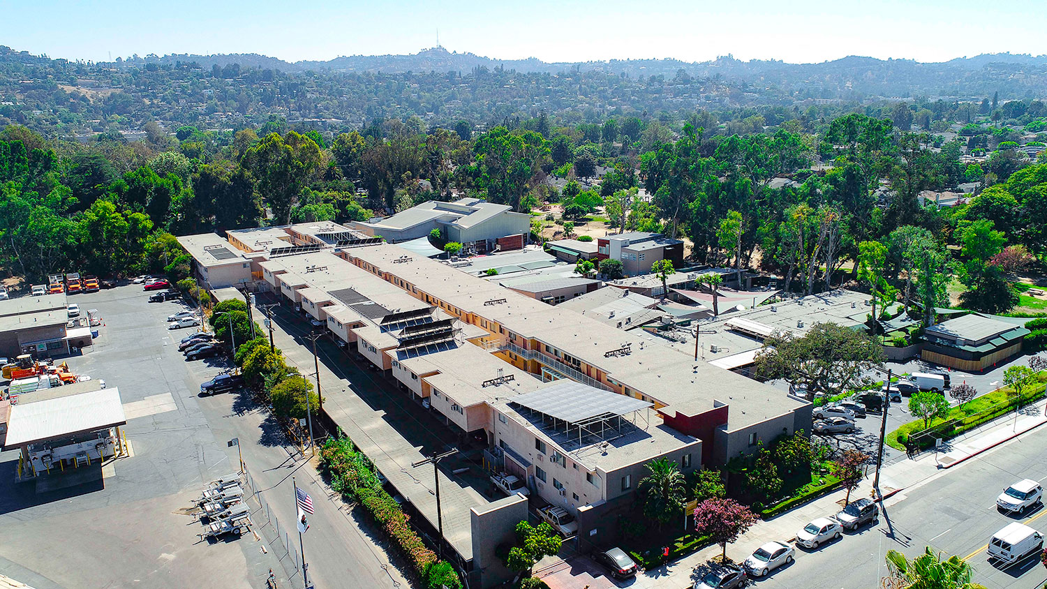 Aerial drone photo of Woodbridge Park Apartments, showing white solar roofs and Solar Panels.