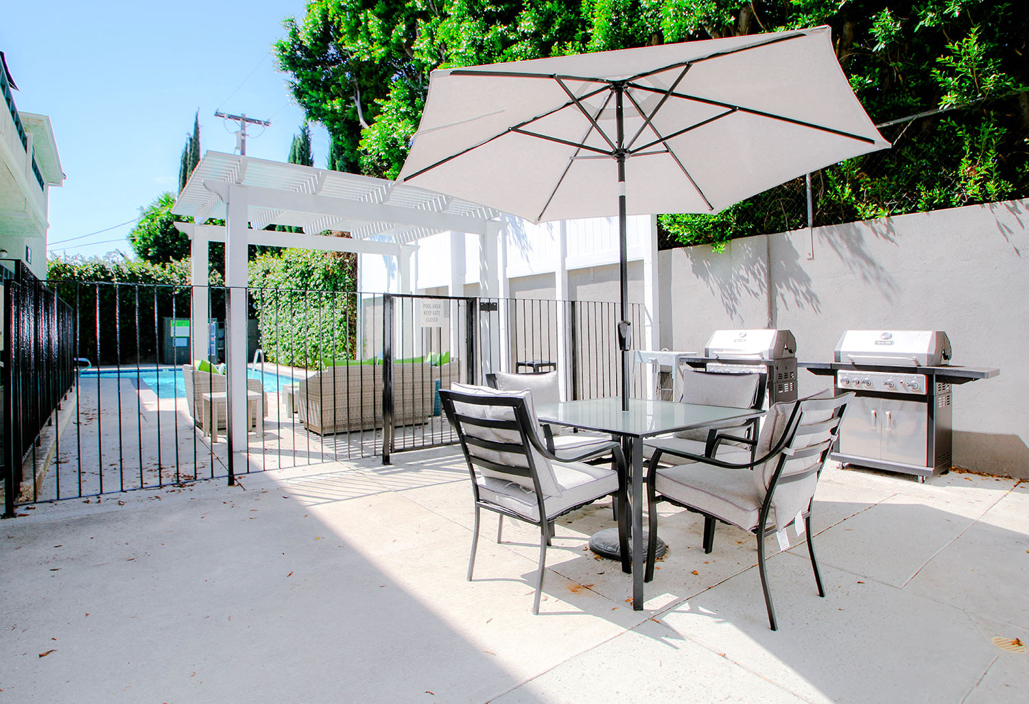Courtyard barbecue and seating area with umbrella.