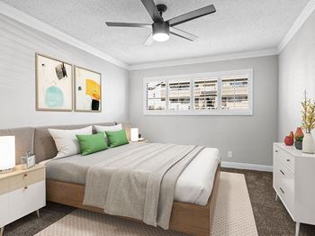 Carpeted bedroom with ceiling fan.