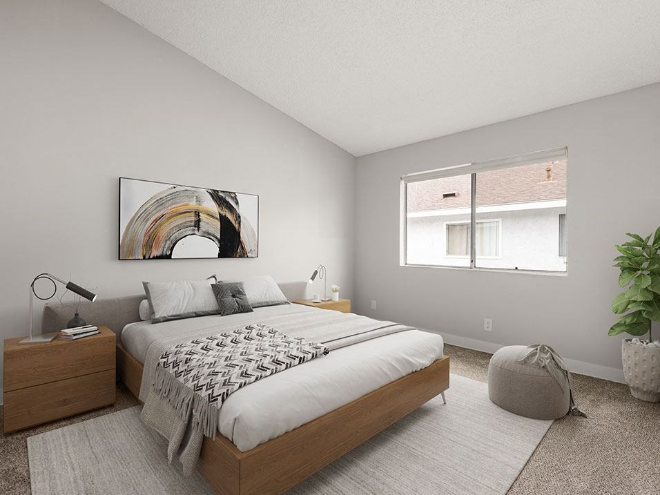 Carpeted bedroom with natural light windows.