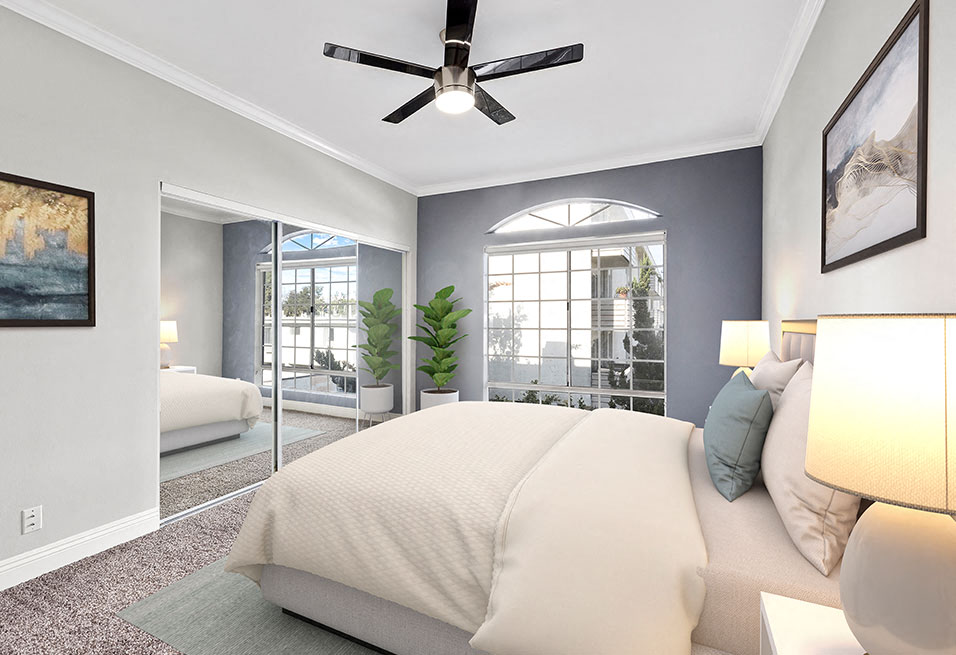 Carpeted bedroom featuring beautiful natural lighting and ceiling fan.