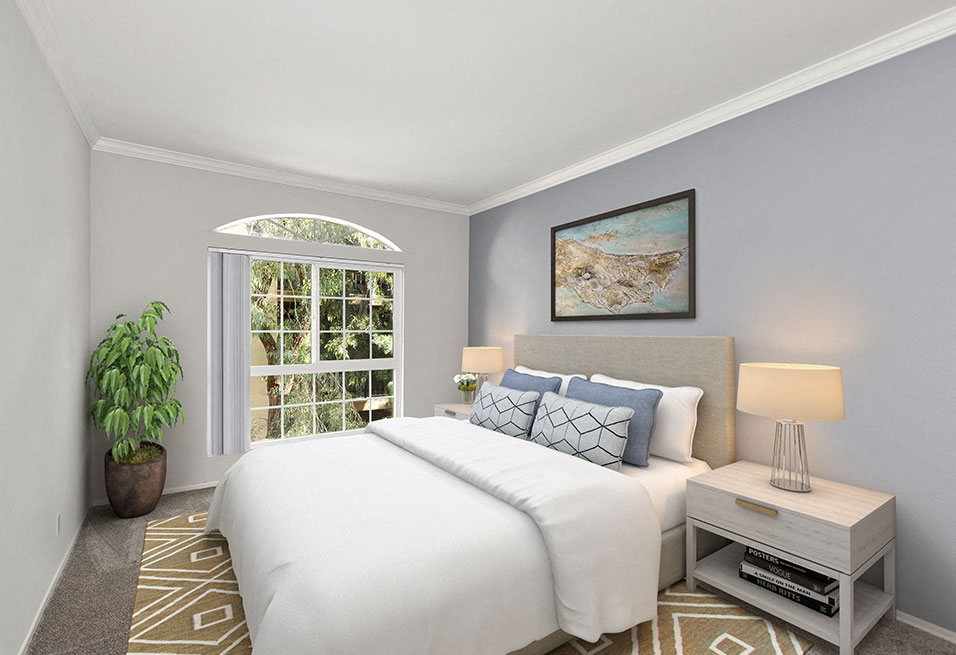 Carpeted bedroom featuring beautiful natural lighting and ceiling fan.