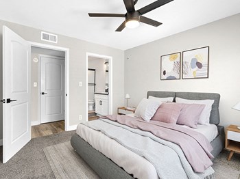 Carpeted bedroom with ceiling fan and private bathroom. Carpeted bedroom with ceiling fan and private bathroom. - Photo Gallery 3