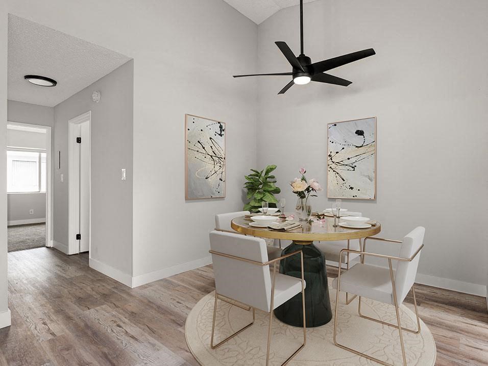 Hardwood floored dining room with view of second bedroom.