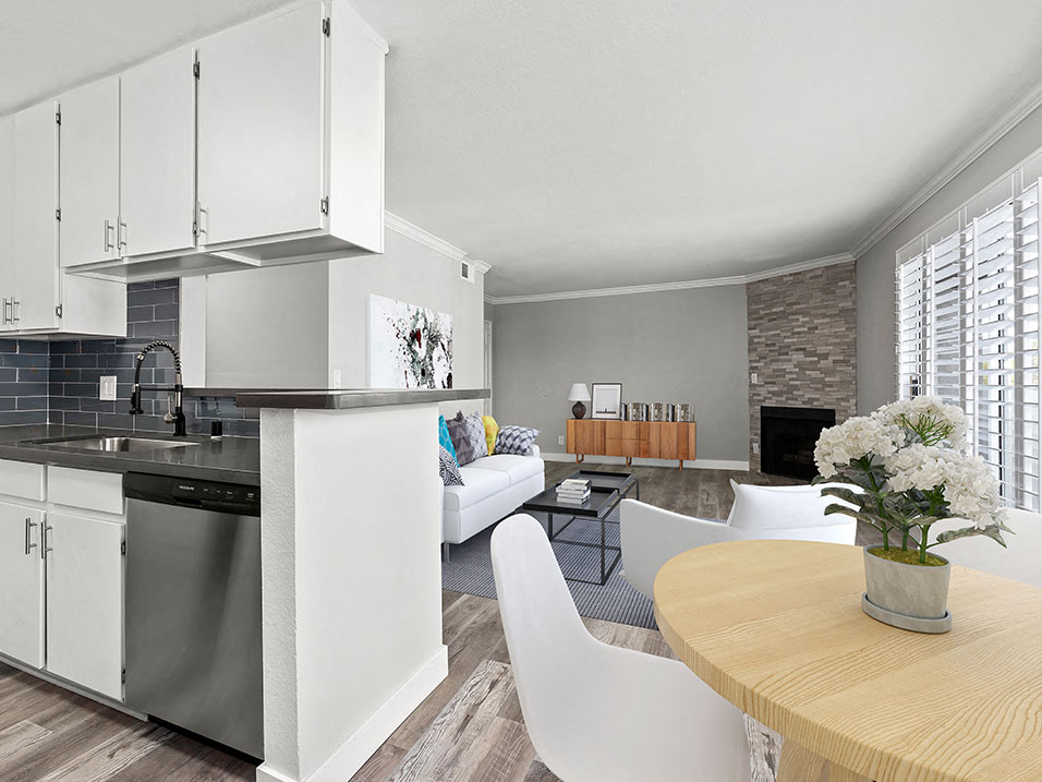 Dining room with view of stone accent wall and stainless steel kitchen.