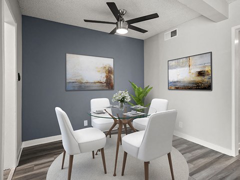 Hardwood floored dining area with celling fan.
