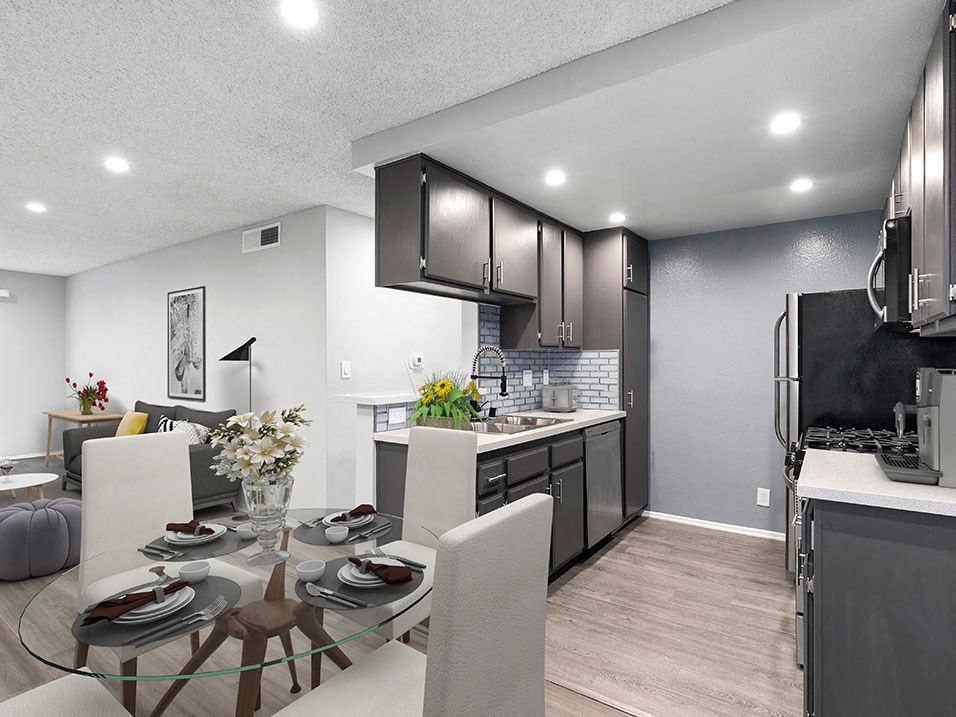 Hardwood floor dining room with view of tiled kitchen area.