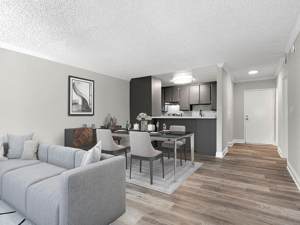 Hardwood floored living room with view of dining room.