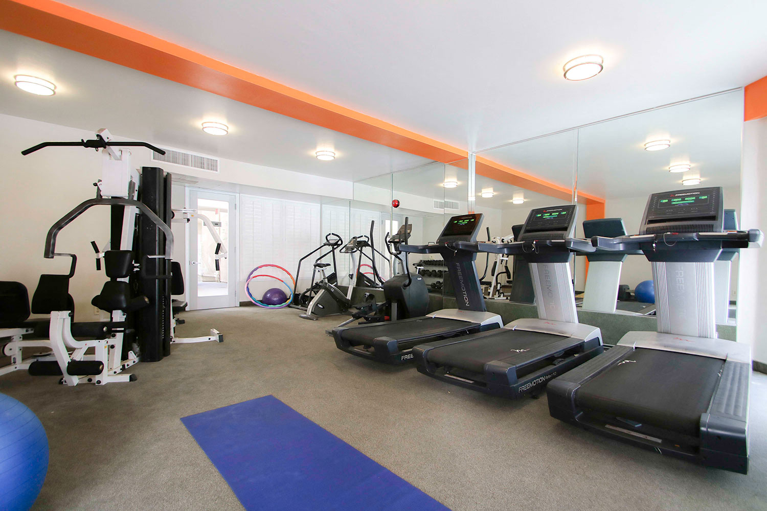 Fitness center including high efficiency treadmills and free weights.