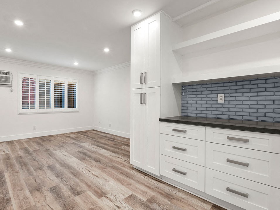 Additional cabinet storage in kitchen with access from living room.