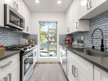 Blue tiled kitchen with stainless steel microwave, oven, and fixtures. Blue tiled kitchen with stainless steel microwave, oven, and fixtures. - Photo Gallery 2