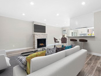 Hardwood floored living room with stone accented fireplace. Hardwood floored living room with stone accented fireplace. - Photo Gallery 5