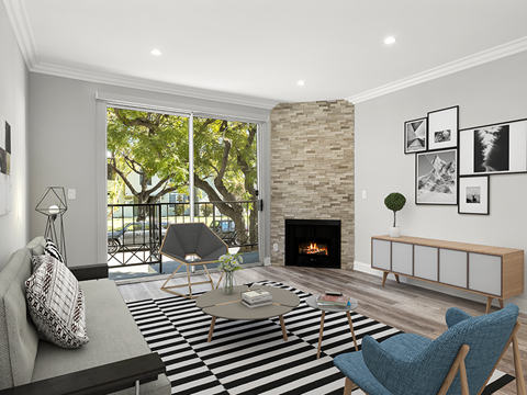 a living room with a fireplace and a checkered rug