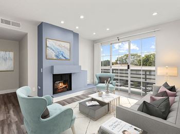 Living room with hardwood floors, patio access, and fireplace.