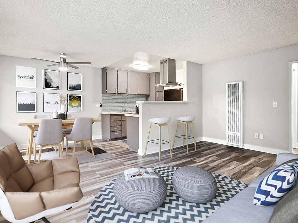 an open living room and kitchen with a couch and chairs