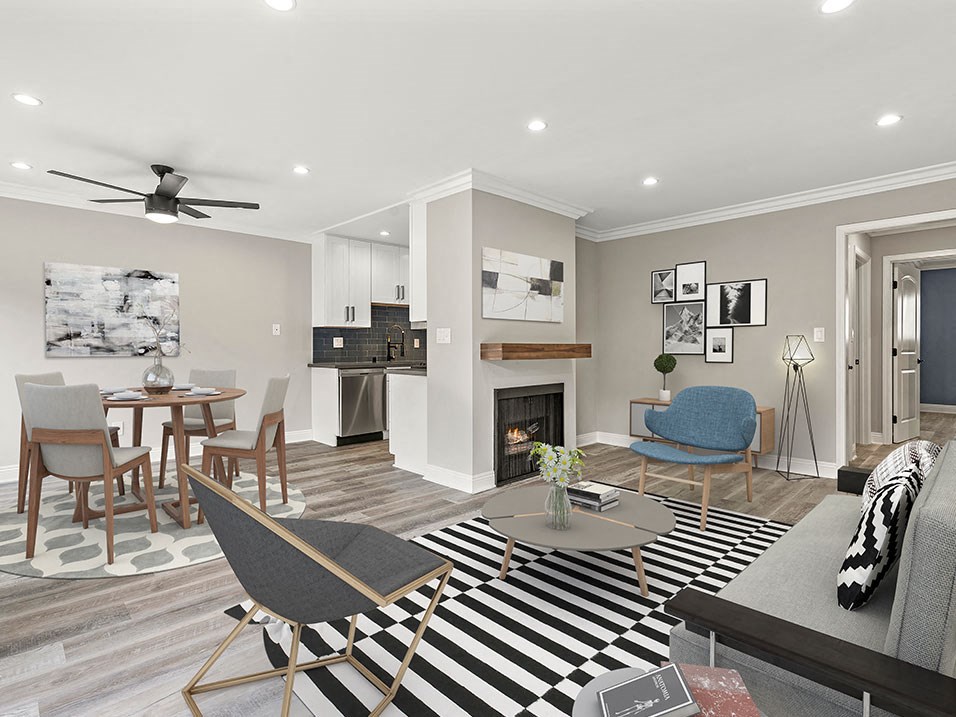 Living room with hardwood floors and view of dining room and kitchen.