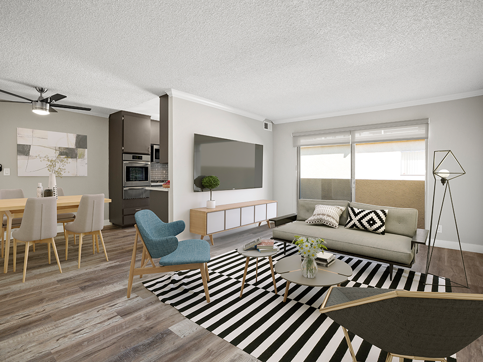Hardwood floored living room with view of dining room and kitchen.