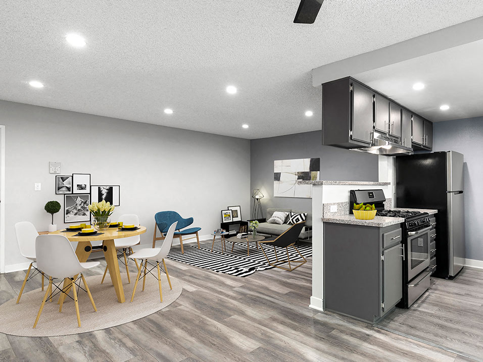 Hardwood floor living room and dining room with view of kitchen.