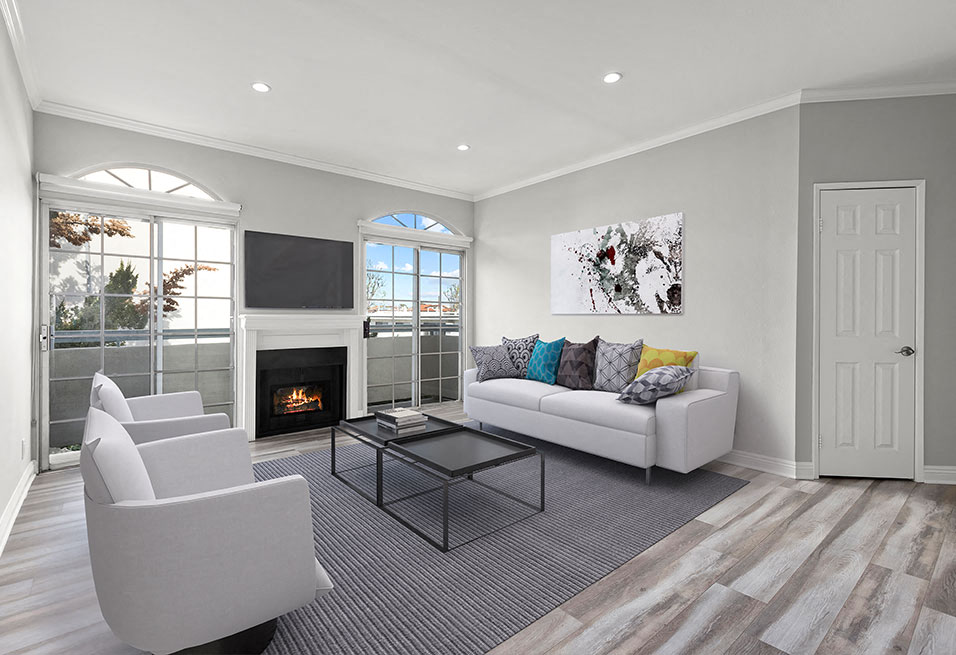 a living room with a couch and chairs and a fireplace