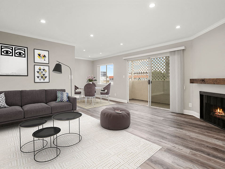Living room with hardwood floors and view of balcony.
