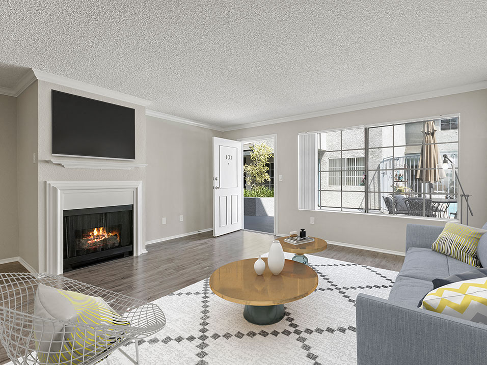 Living room with hardwood floor and large windows for natural light.