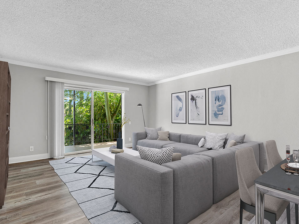 Hardwood floored living room with view of outdoor patio.