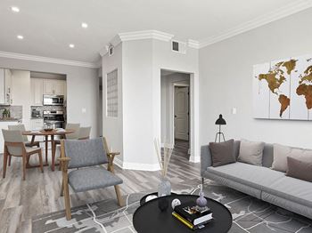 Hardwood floored living room with view of dining room.