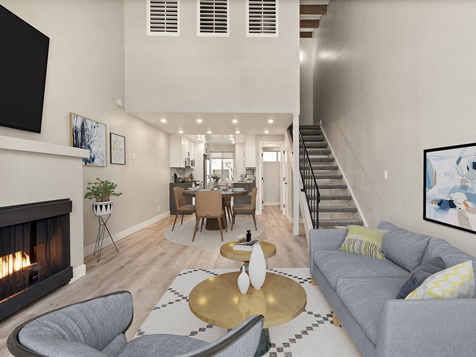 Hardwood floored living room with fireplace and access to loft above.