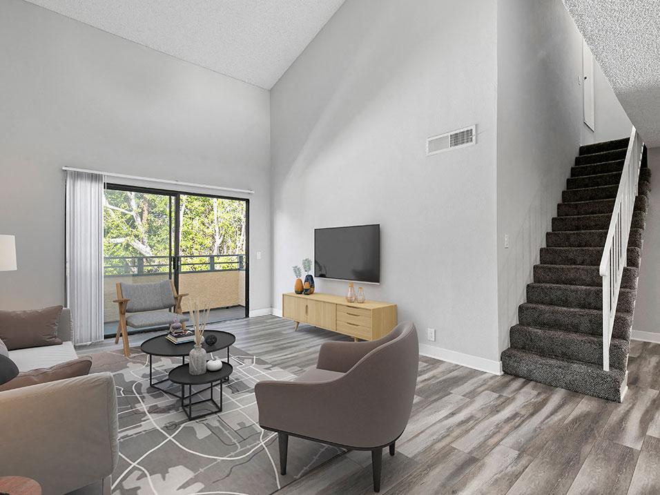 Hardwood floor living room with view of loft staircase.
