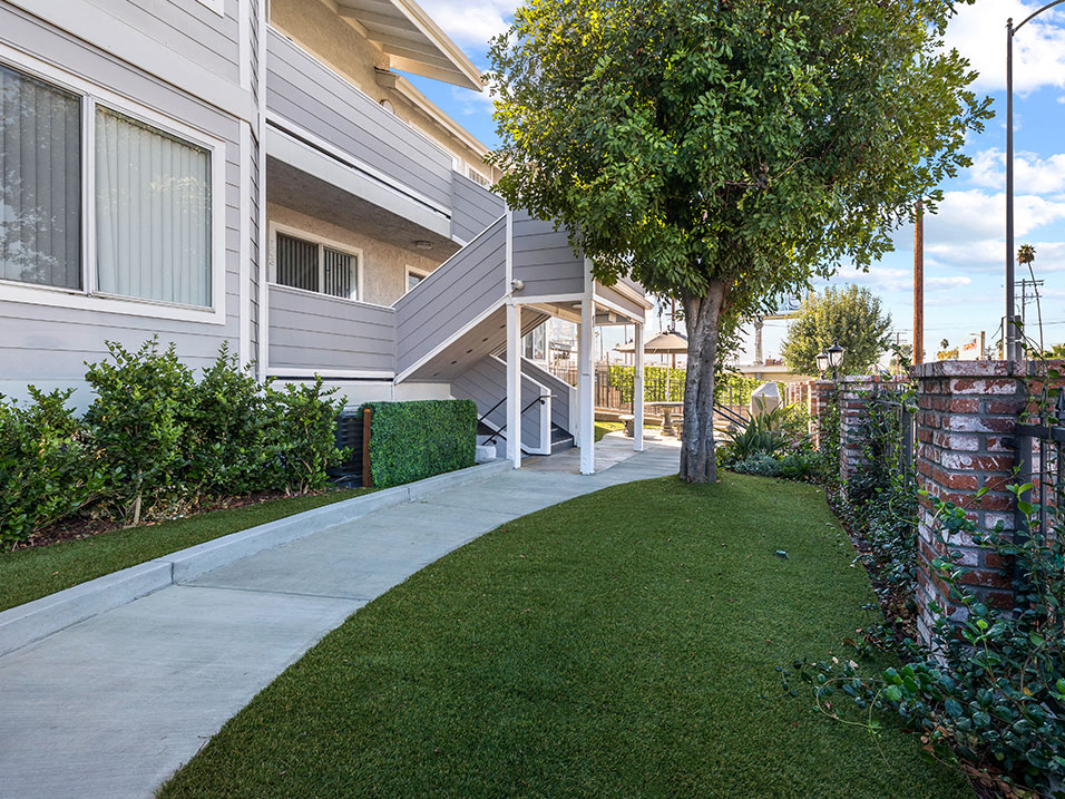 Exterior walking path in gated patio area.