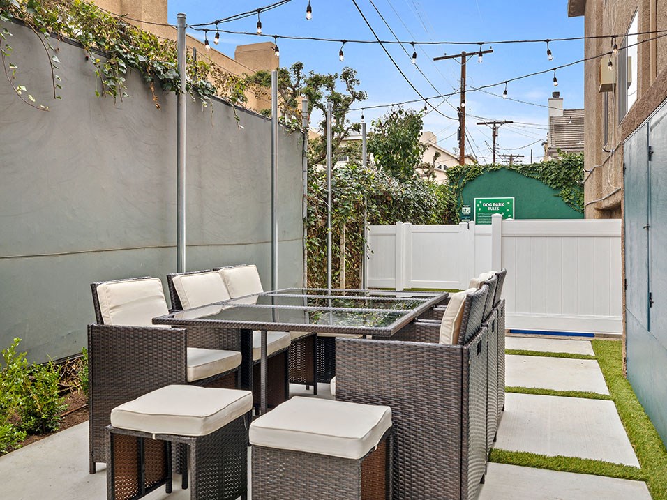 Fenced outdoor picnic area near dog park.