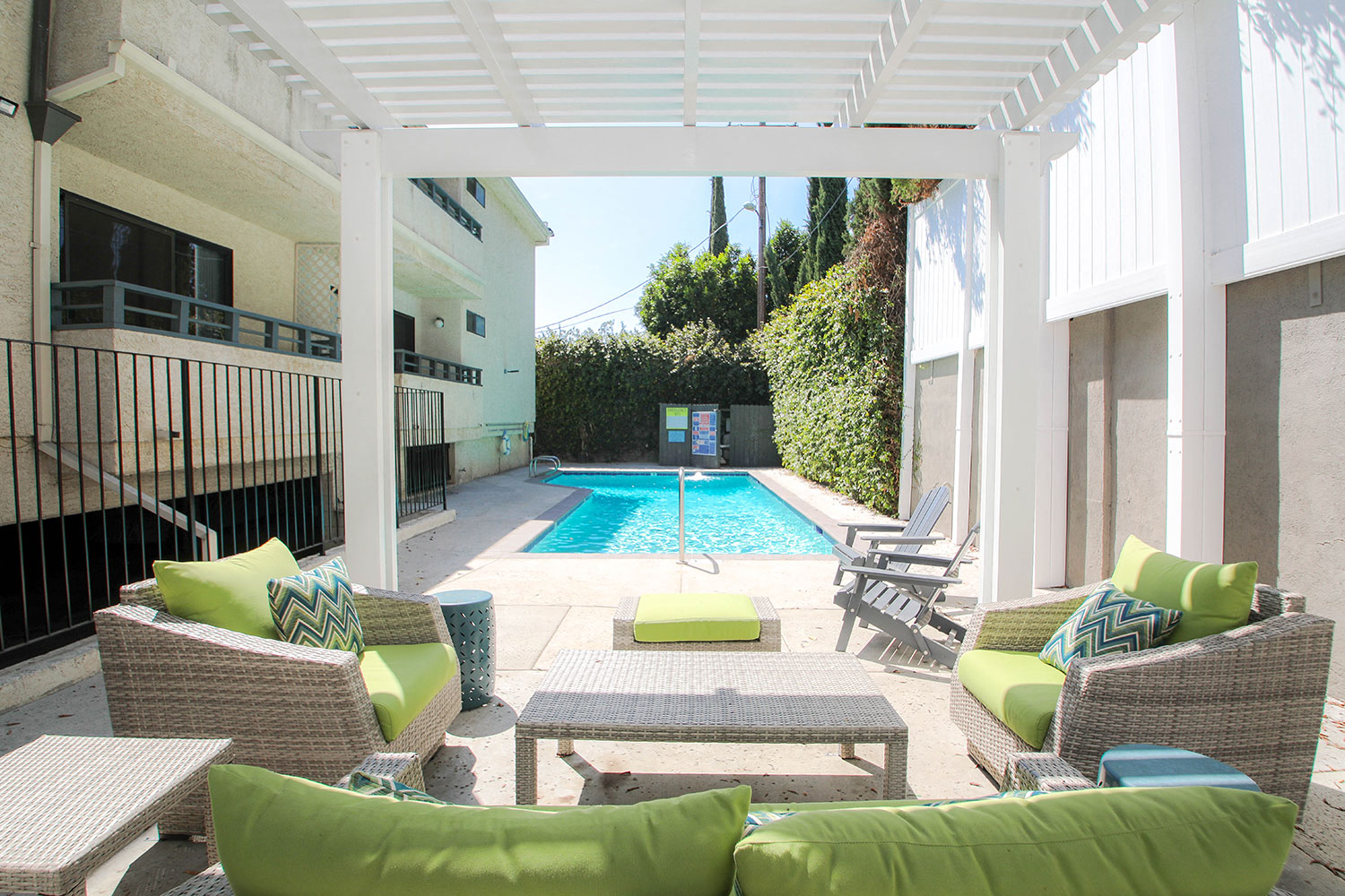 Exterior pool seating area with lounging space.