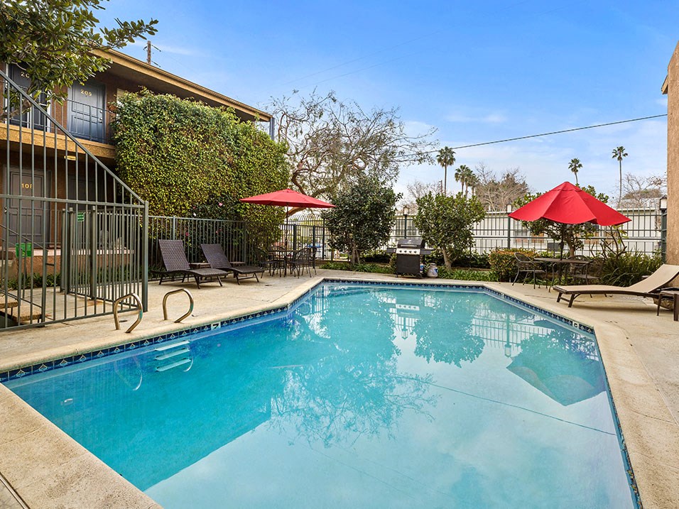 Fenced courtyard pool and BBQ area.