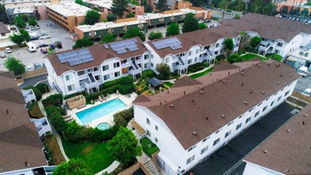 Aerial drone view of roof showcasing solar panels for a low carbon footprint. - Photo Gallery 26