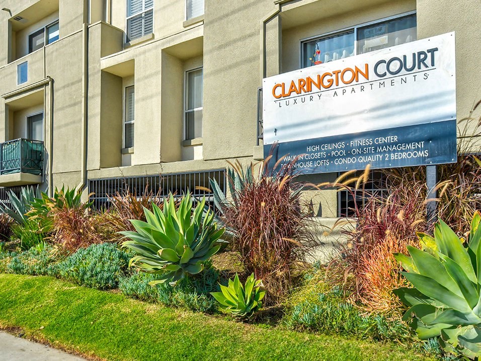 a building with a sign in front of a garden