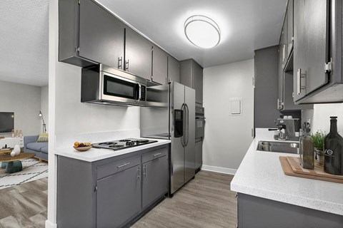 a kitchen with stainless steel appliances and a white counter top