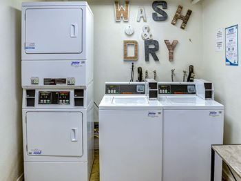 A laundry room with wash and dry machines.