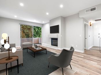 A modern living room with a grey chair and a coffee table.