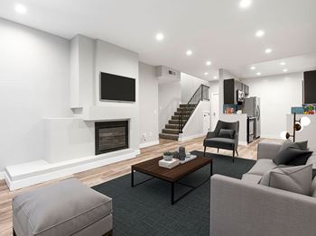 A modern living room with a fireplace and a staircase.