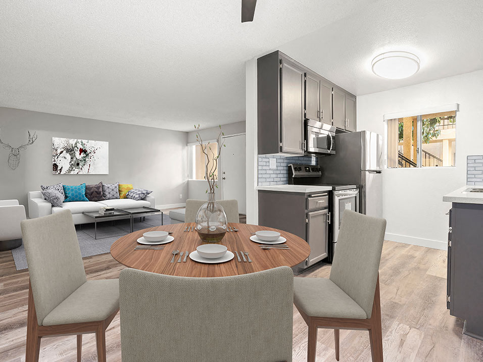 A modern kitchen with a dining table set for four.