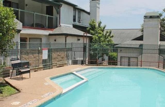 a swimming pool in front of an apartment building