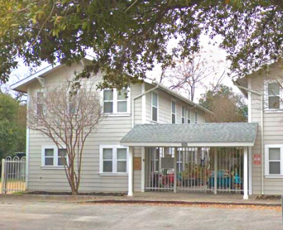 a white house with a screened in porch